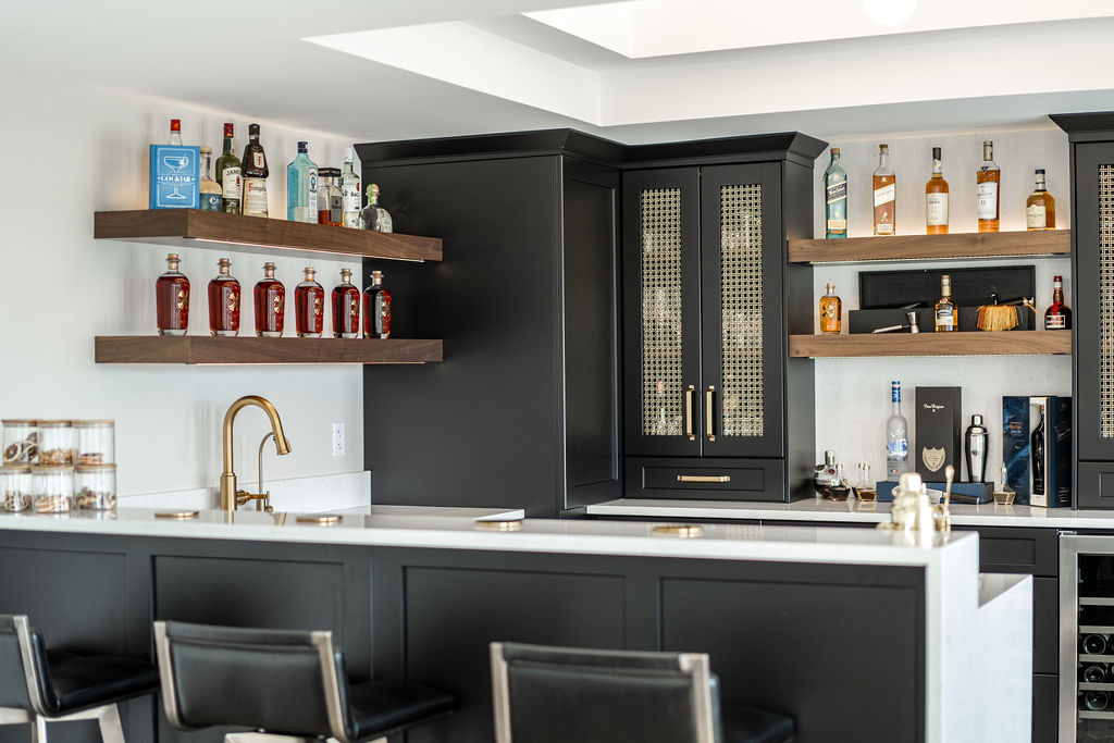 Walkout basement with dark cabinetry and gold accents, bright and spacious with floor to ceiling windows