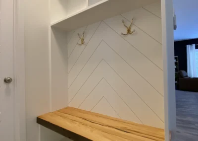 custom wooden bench and overhead storage with herringbone shiplap by Axium Interiors in Saskatoon