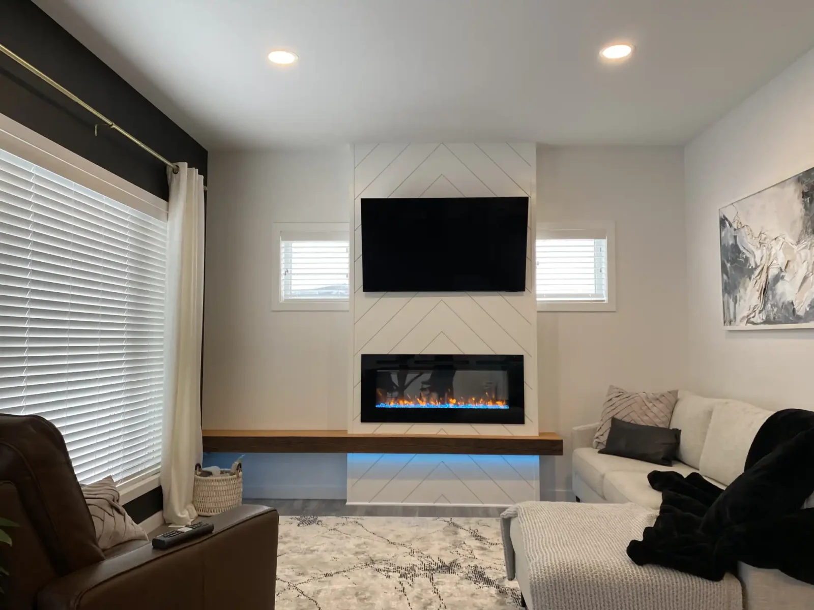 Walkout basement with dark cabinetry and gold accents, bright and spacious with floor to ceiling windows 