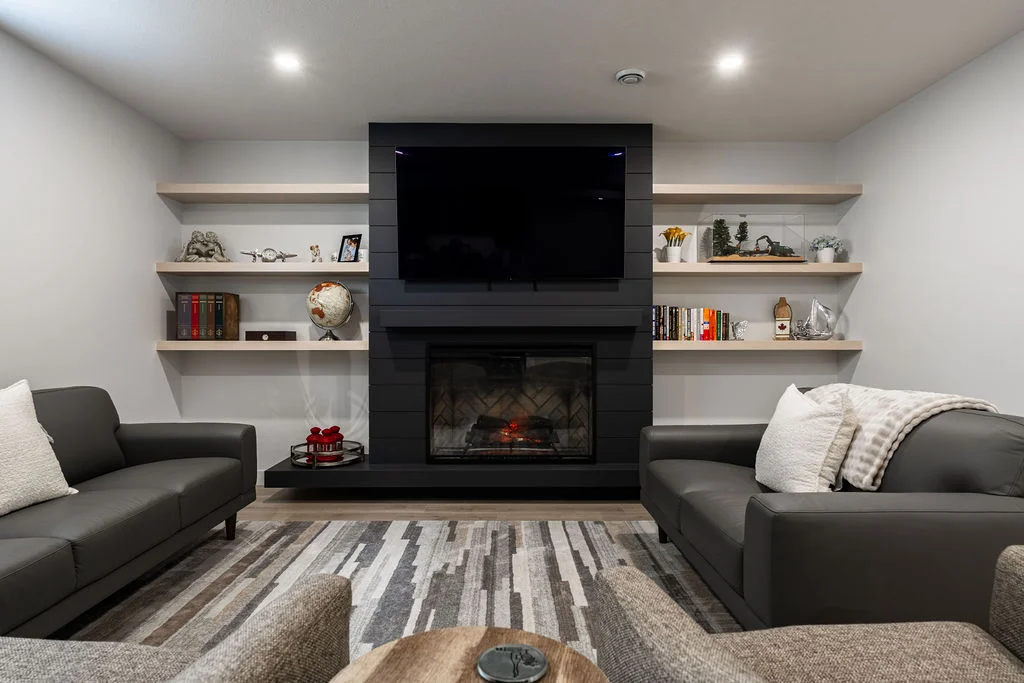 Walkout basement with dark cabinetry and gold accents, bright and spacious with floor to ceiling windows 