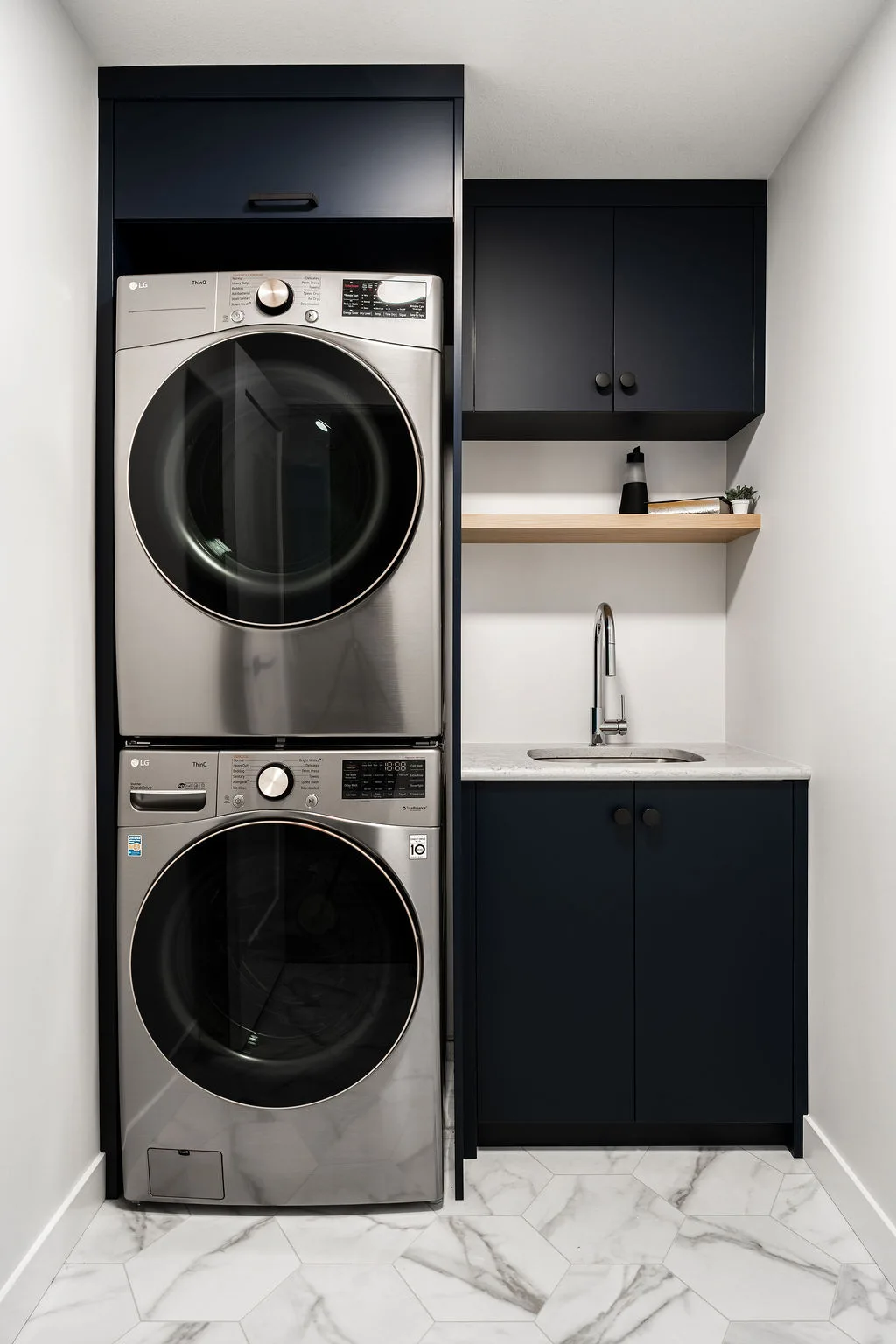 Walkout basement with dark cabinetry and gold accents, bright and spacious with floor to ceiling windows 